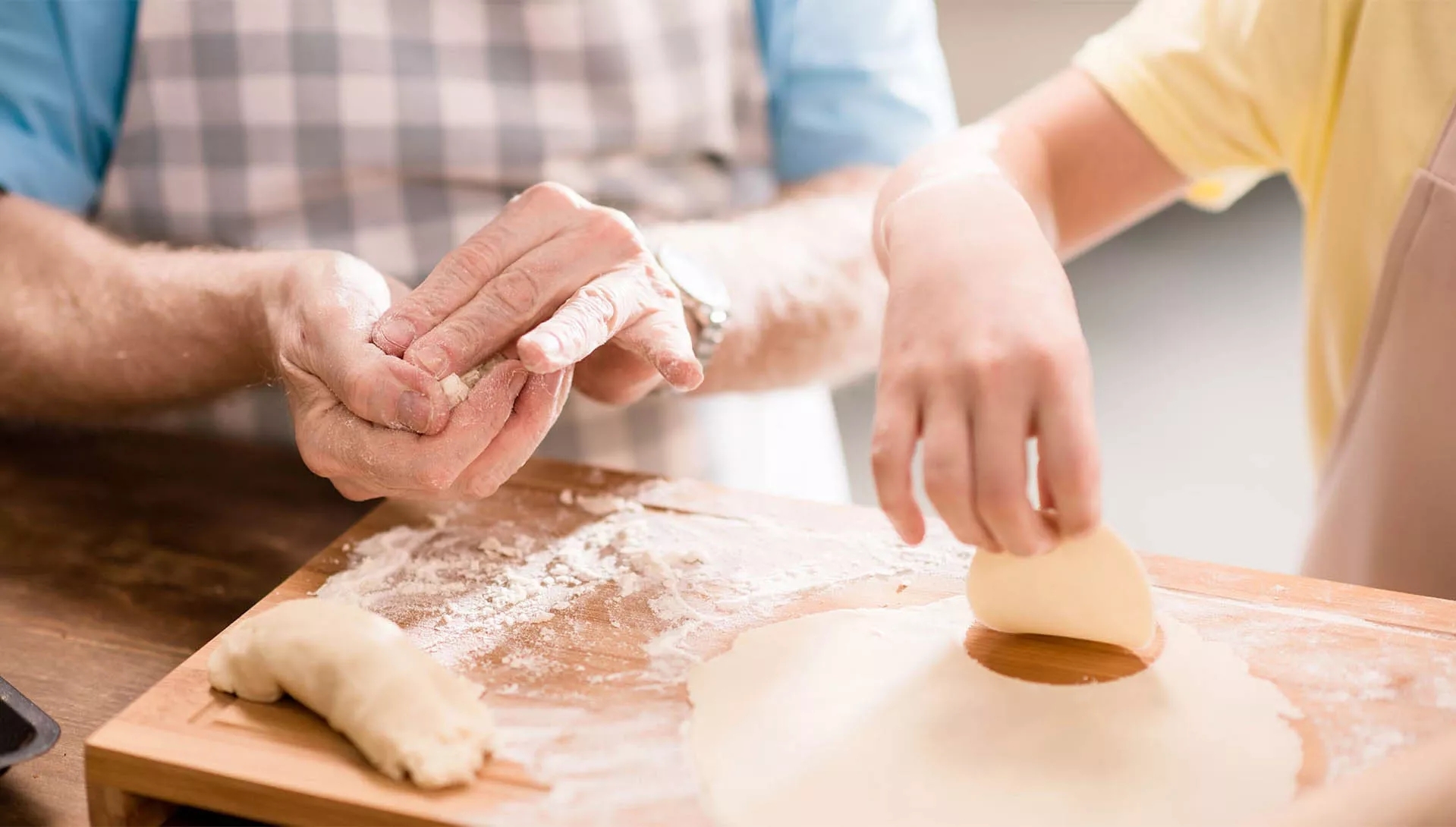Two people mixing dough Two people mixing dough