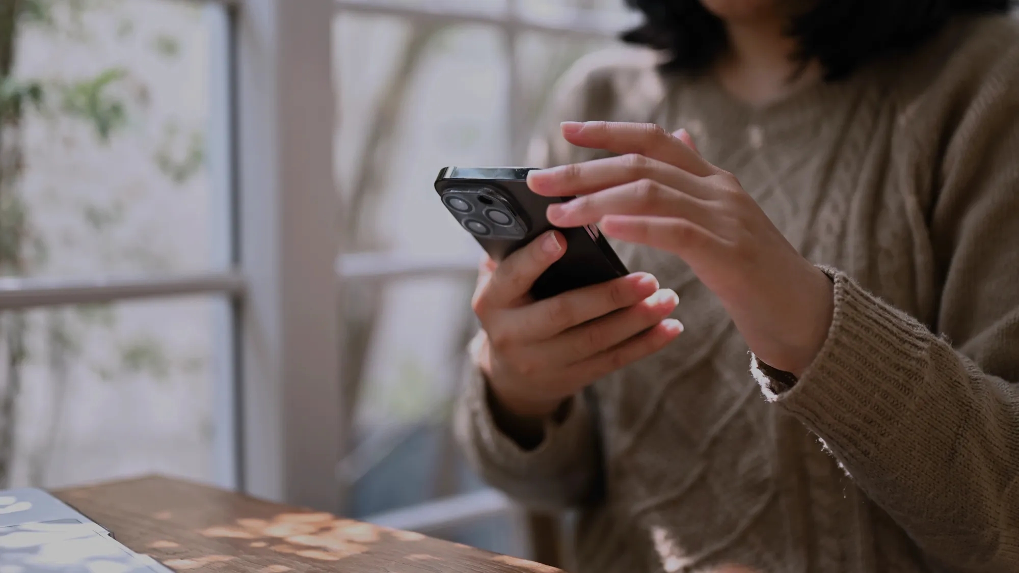 A person holding a mobile phone. A person holding a mobile phone.