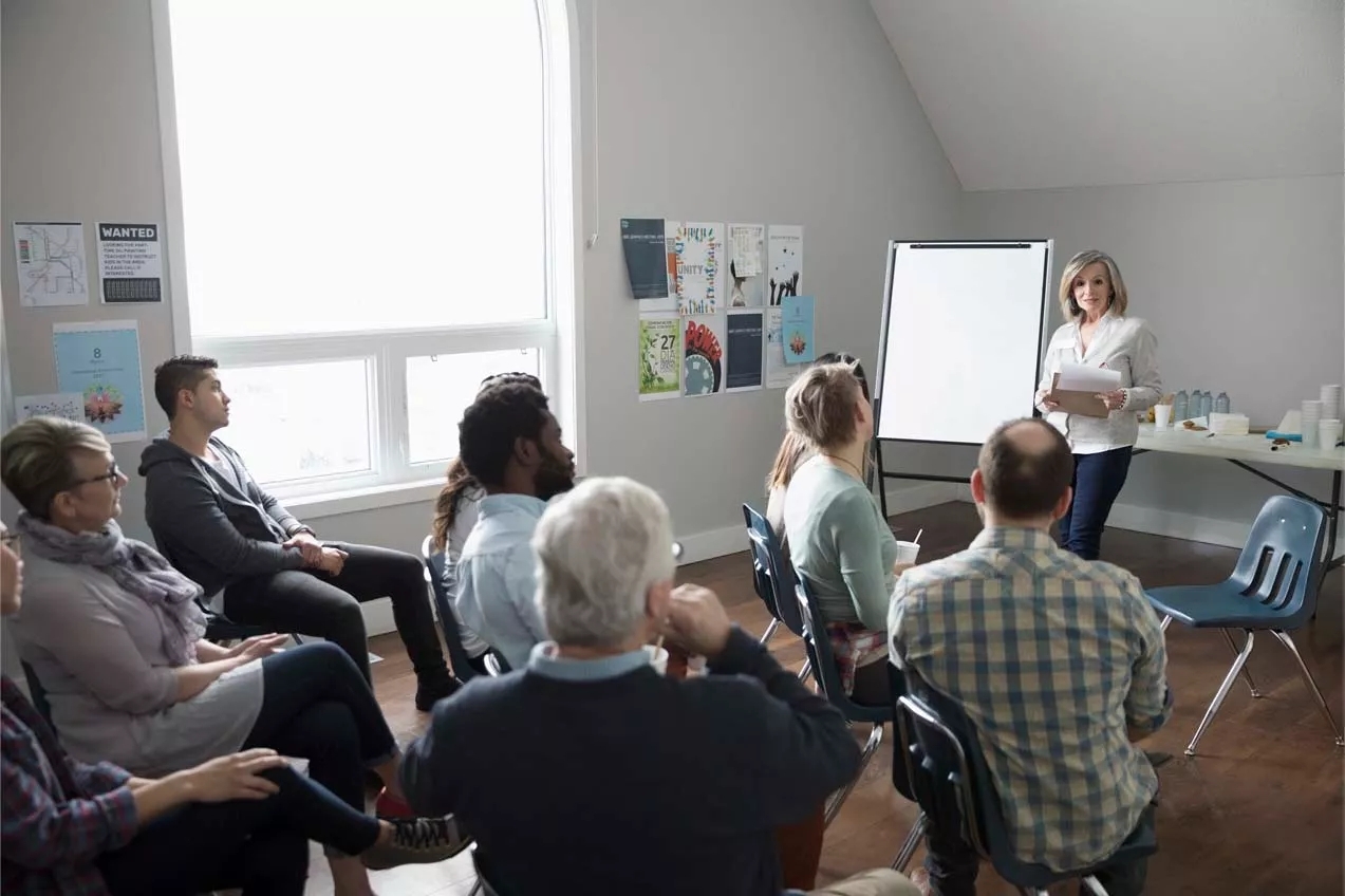 bunch of people having a meeting and a person speaking to the whole group bunch of people having a meeting and a person speaking to the whole group