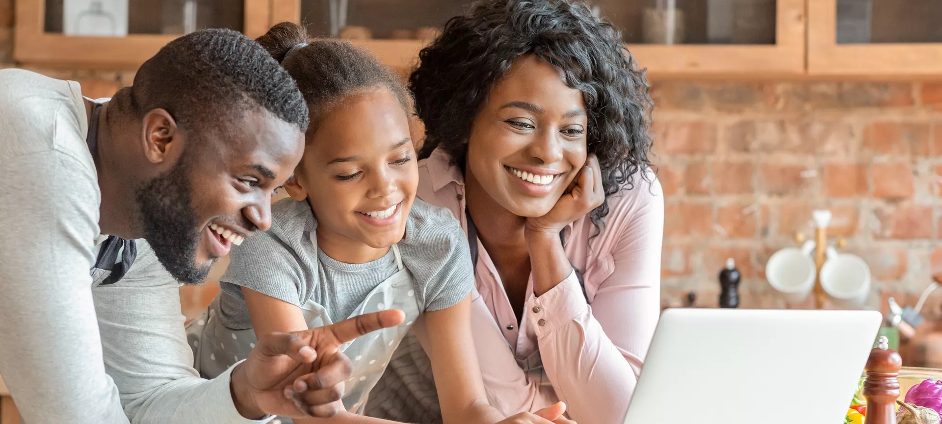 Family of three looking at a laptop. Family of three looking at a laptop.