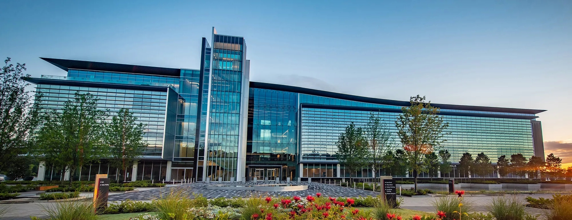 Bank OZK Headquarters in Little Rock Arkansas. There is a sunset to the right of the impressive, stylized glass office building. Bank OZK Headquarters in Little Rock Arkansas. There is a sunset to the right of the impressive, stylized glass office building.