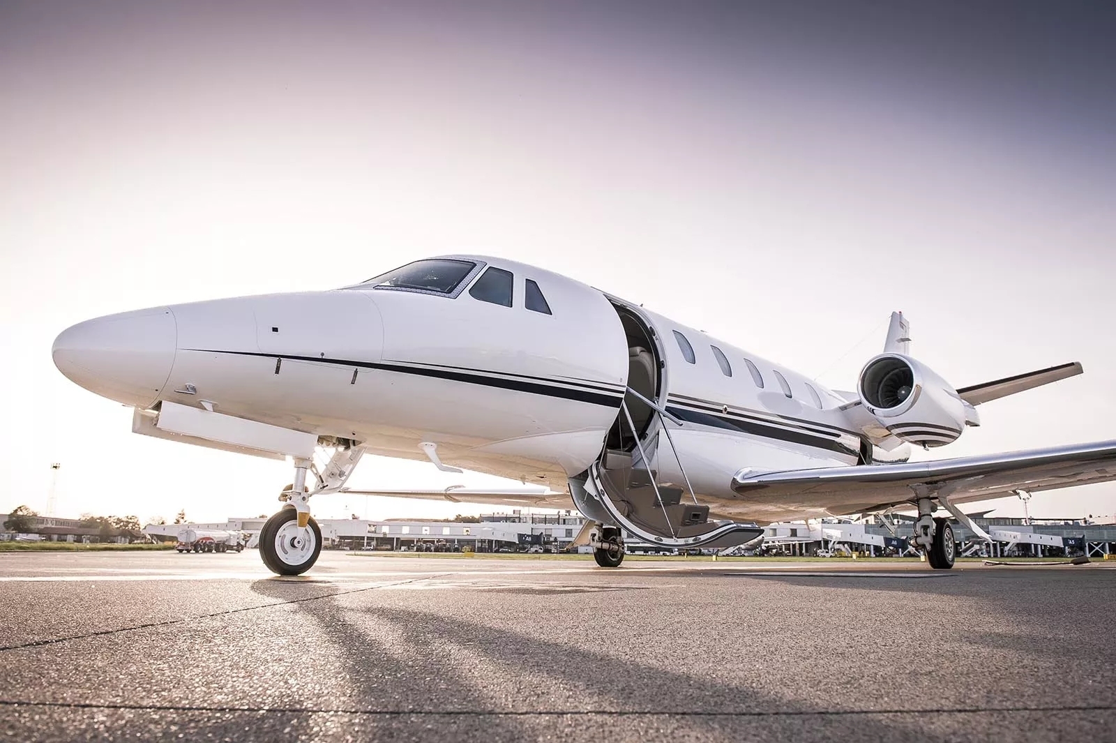 An aircraft parked on the runway, door open. An aircraft parked on the runway, door open.