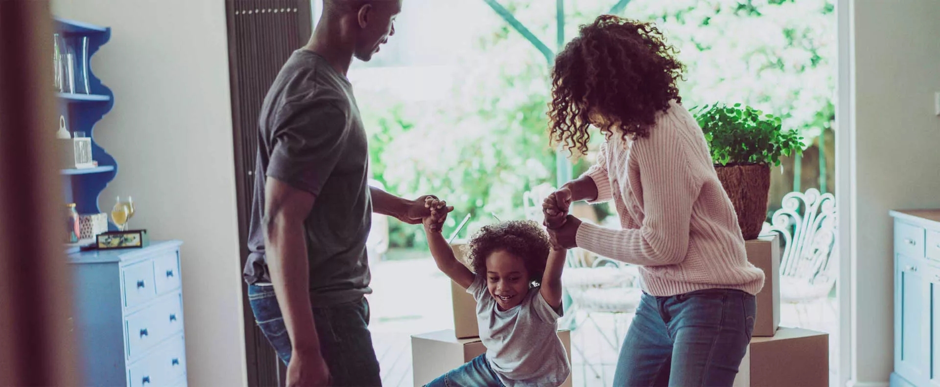 Man and a women holding hands of a child helping her walk. Man and a women holding hands of a child helping her walk.
