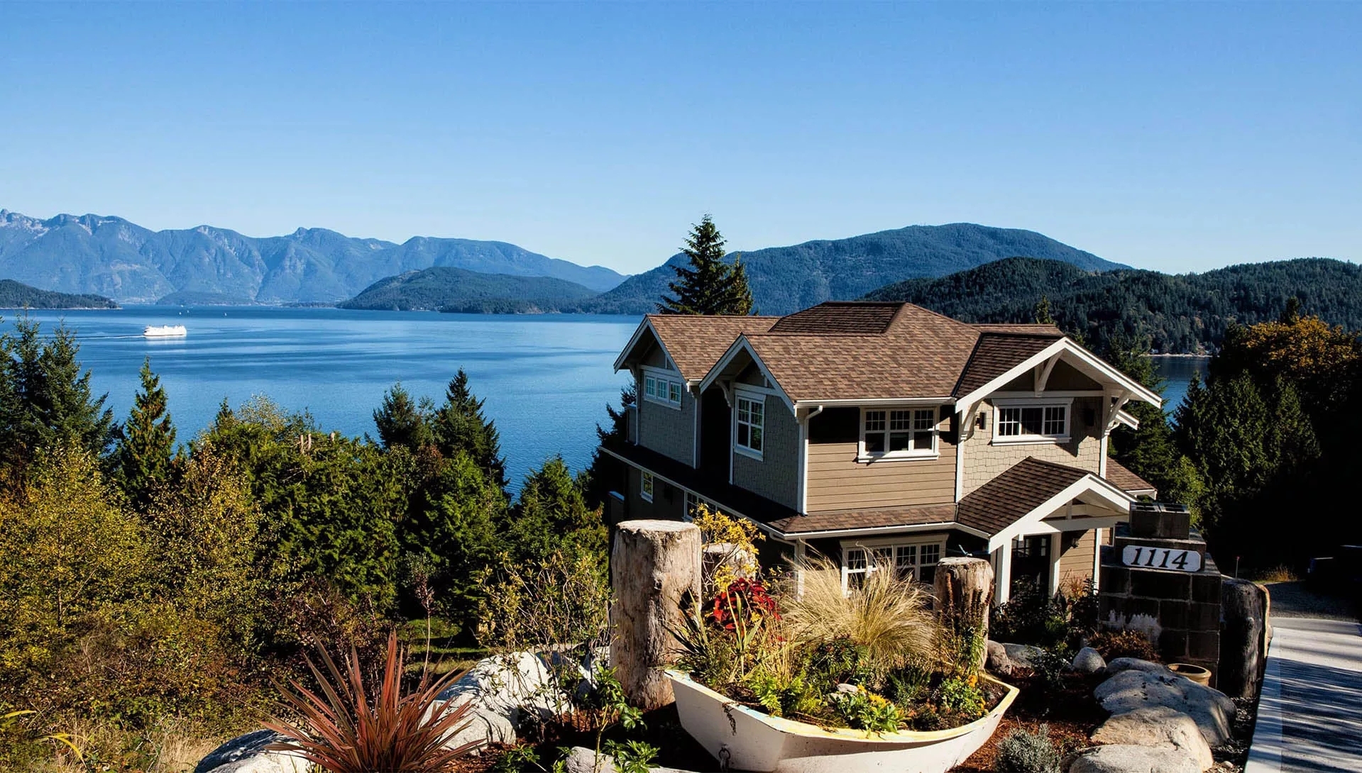 A large, new home overlooking a mountain valley filled as a lake. A large, new home overlooking a mountain valley filled as a lake.